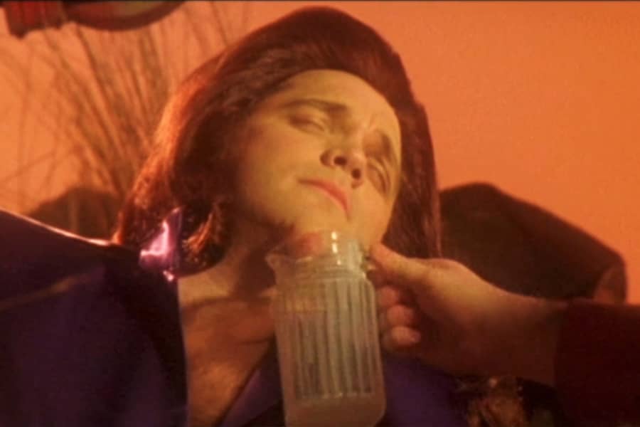 Nimron’s chin is expelling liquid into a glass