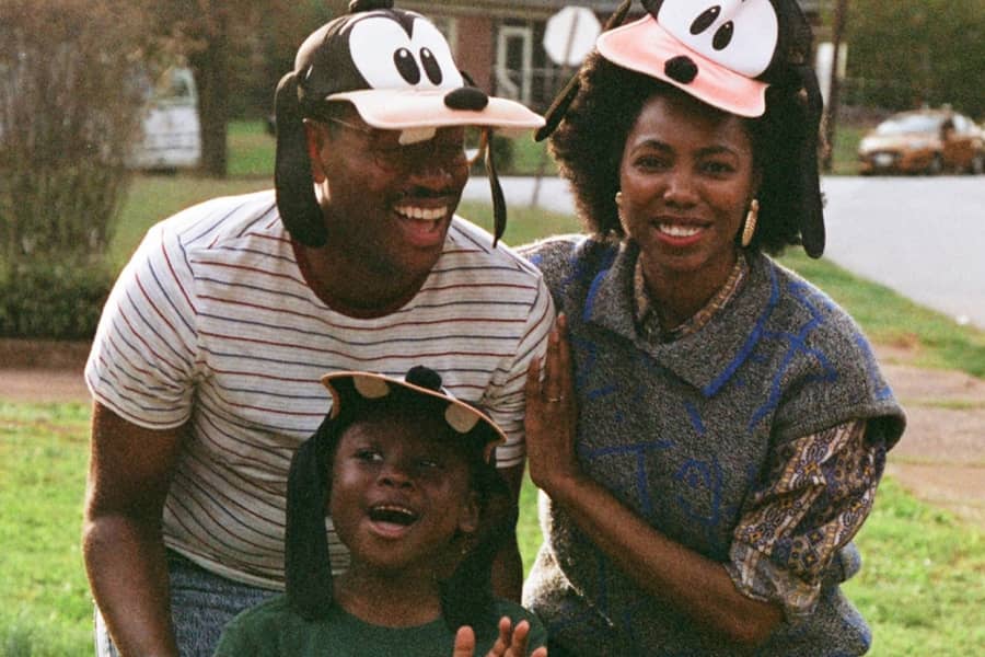 a Black couple and their son wearing Goofy hats