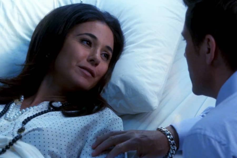 Grinder speaking with a woman in a hospital bed