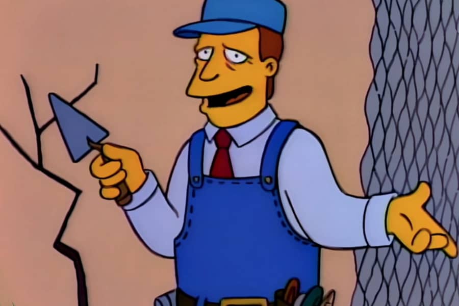 McClure with a trowel in front of a crack and some chicken wire