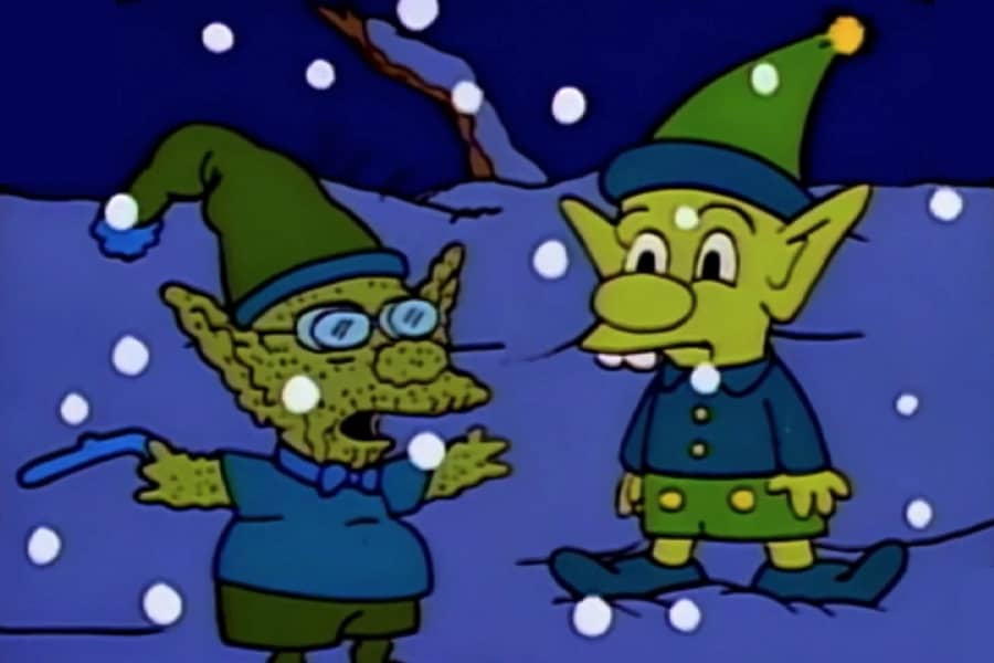 a young and old elf talk in the snow