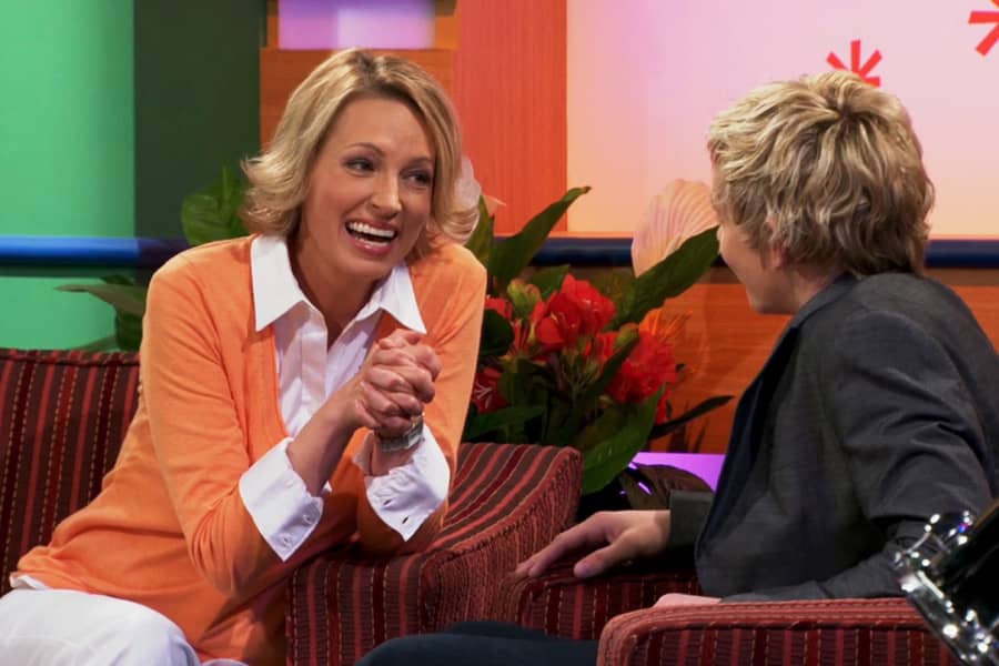 Helen leaning in and smiling at a young male guest