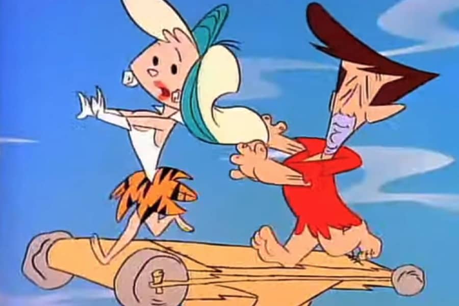 another woman running away from a guy on a rudimentary treadmill
