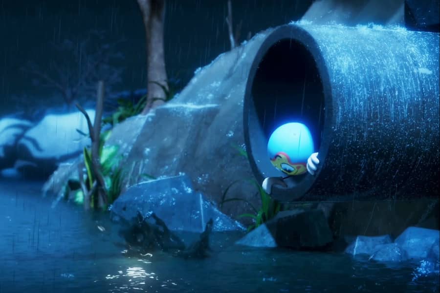 Candy Dufresne poking his head out of a large pipe draining into a stream