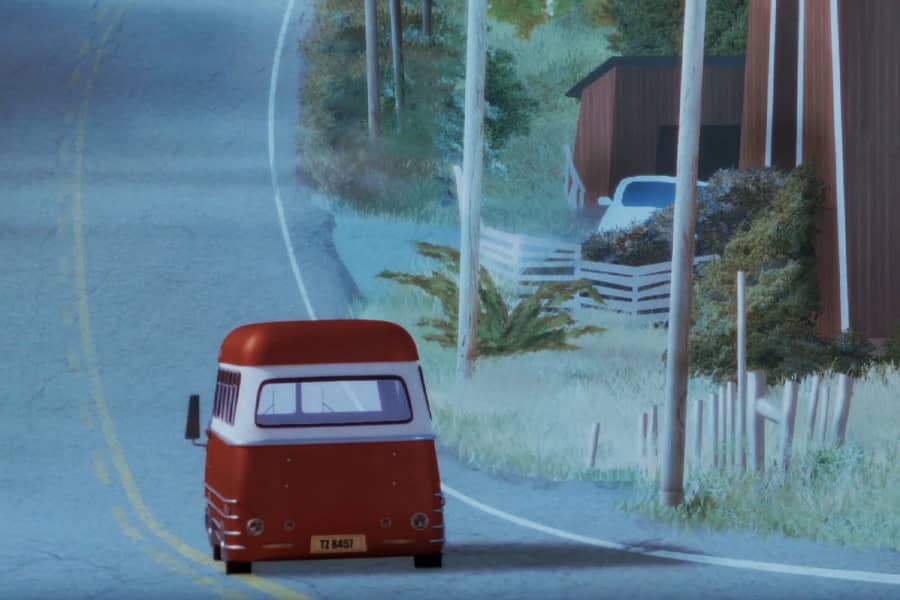 a red van travels down the road