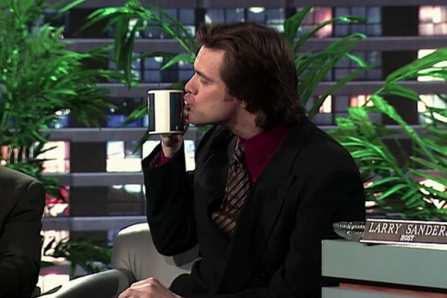 guest Jim Carrey kisses a mug of coffee