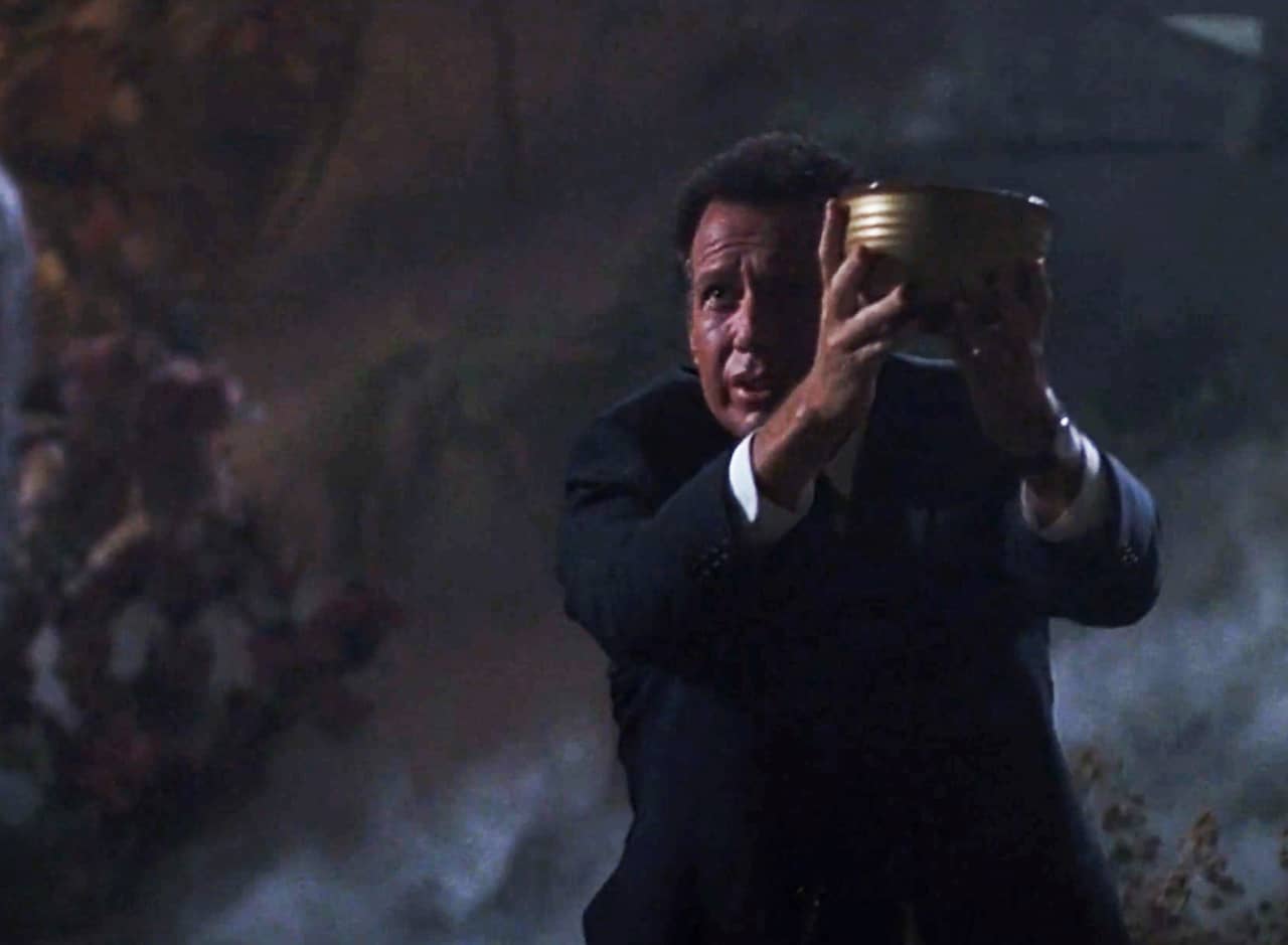 Garry Shandling as Mulder holding up a golden bowl