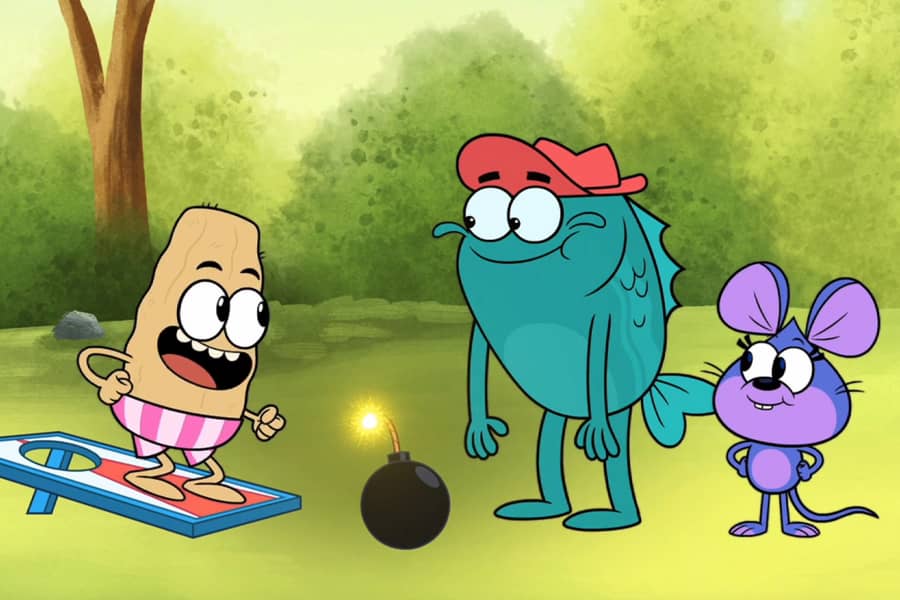Louie standing on the corn hole board next to the bomb