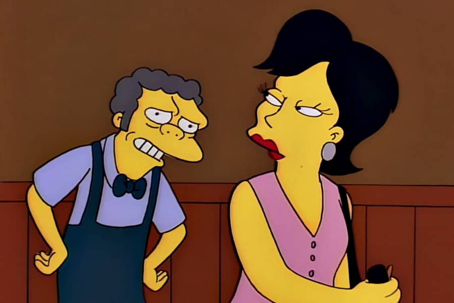 Moe smiling at a woman using the machine