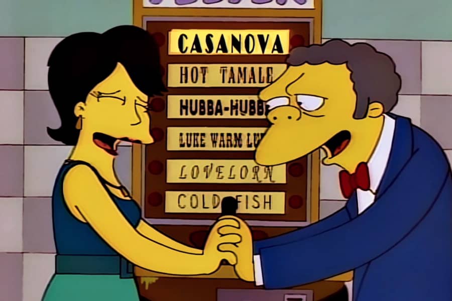 Moe and the woman holding hands in front of the machine