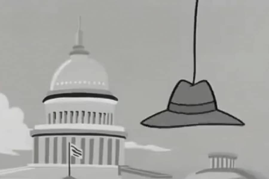 a fedora hat hanging from a string in front of the Capitol