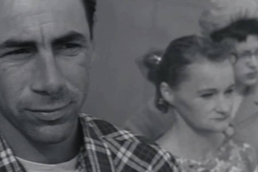 man and two women stand observing