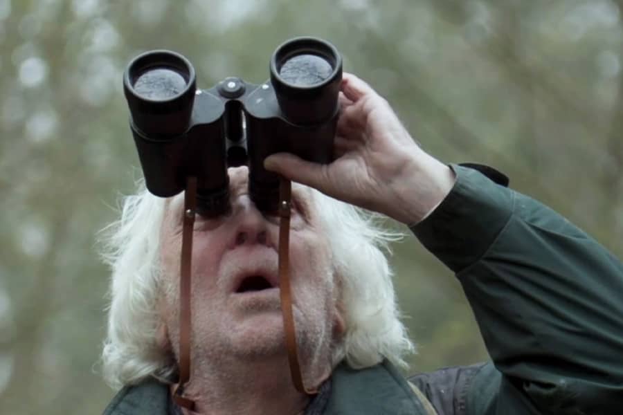 Horace looking up through binoculars