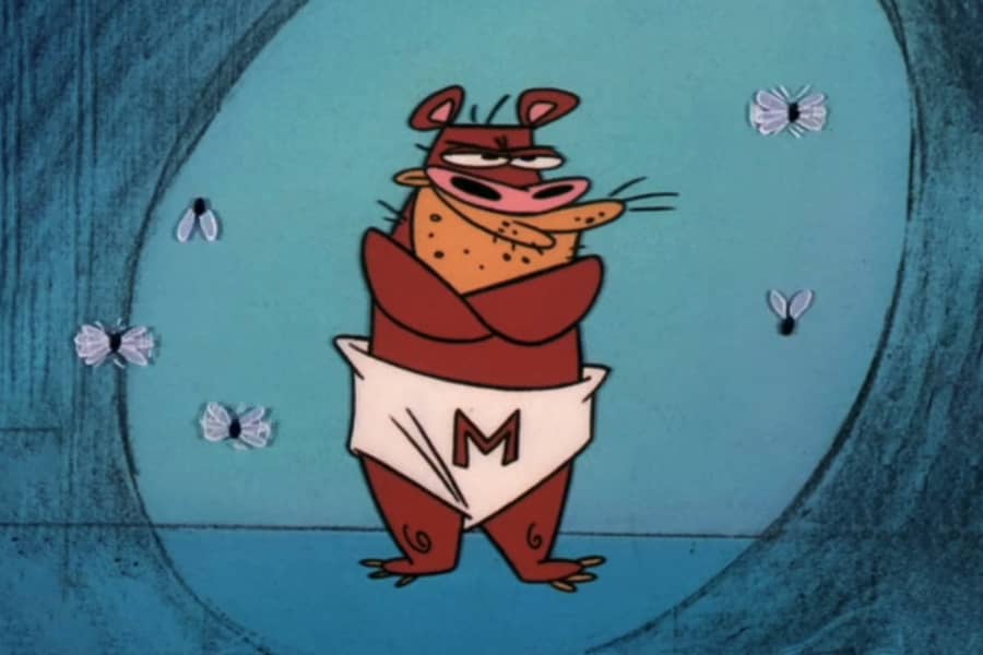 Manure the Bear standing with crossed arms