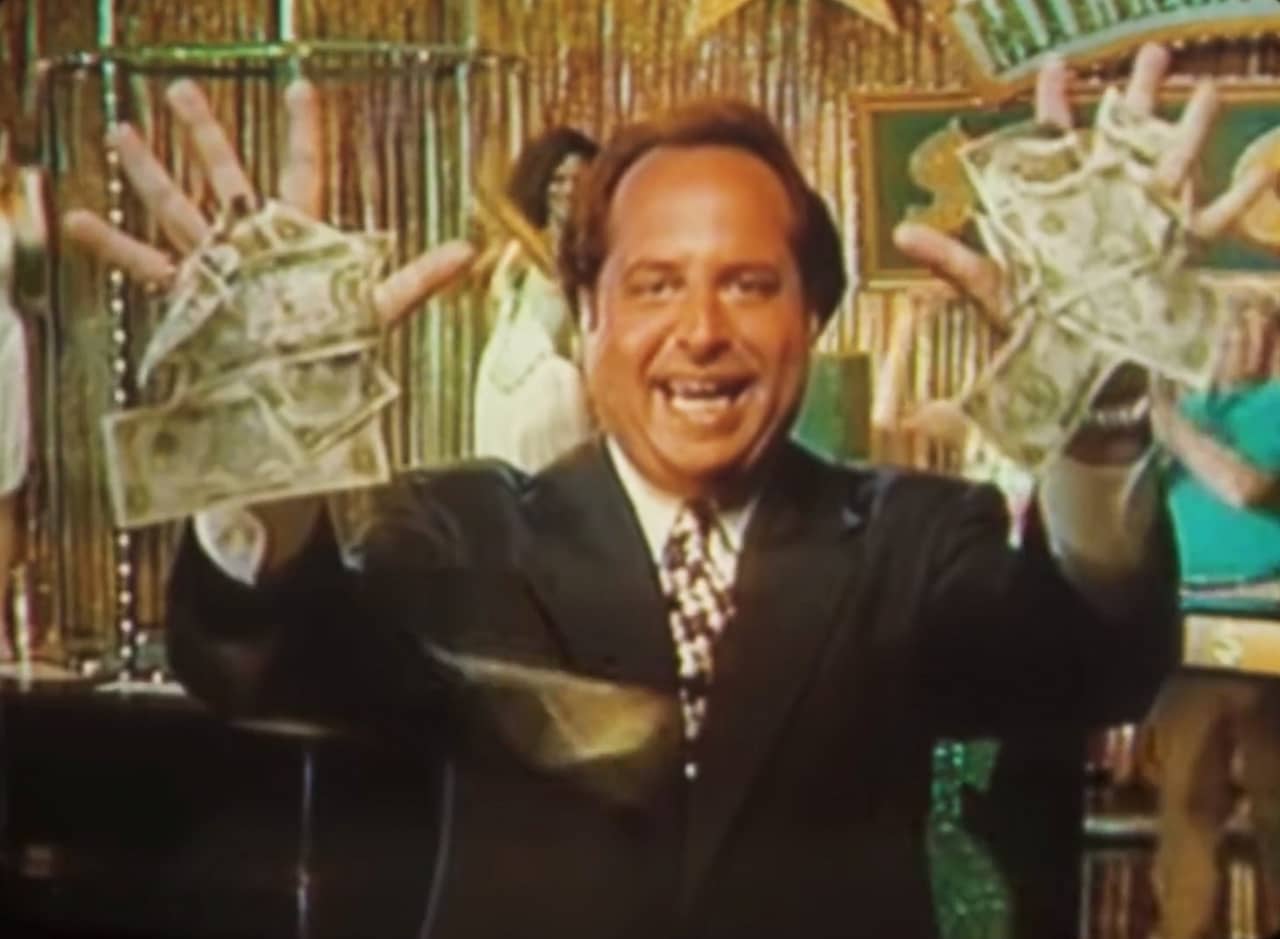 host Mickey with cash stuck to his palms