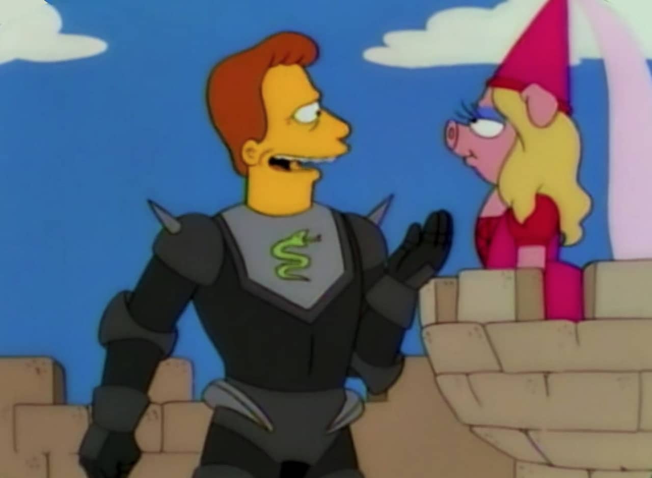 Troy McClure woos Miss Piggy on a stone balcony