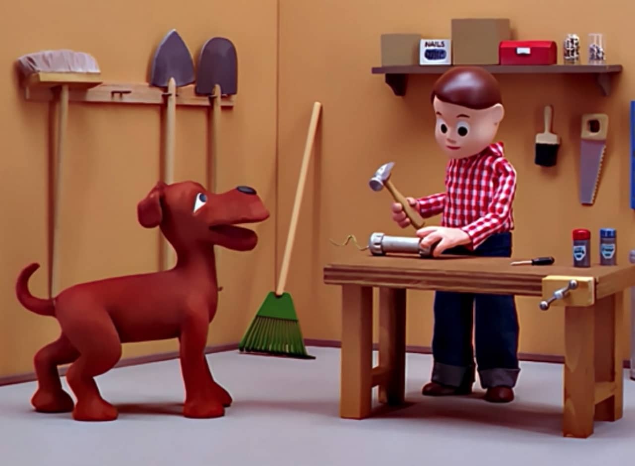 a claymation dog, Jobriath, and boy, Gravey, in a workshop