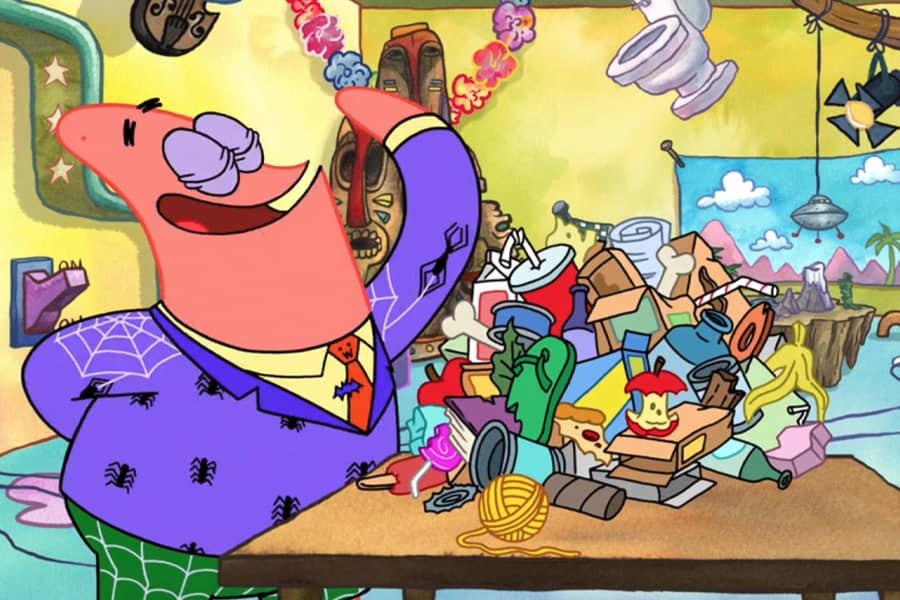 Patrick next to a pile of garbage