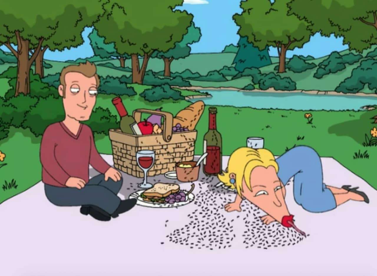 Jude Law on a picnic blanket with Renee Zellwegger who has an elongated nose and is eating up some ants