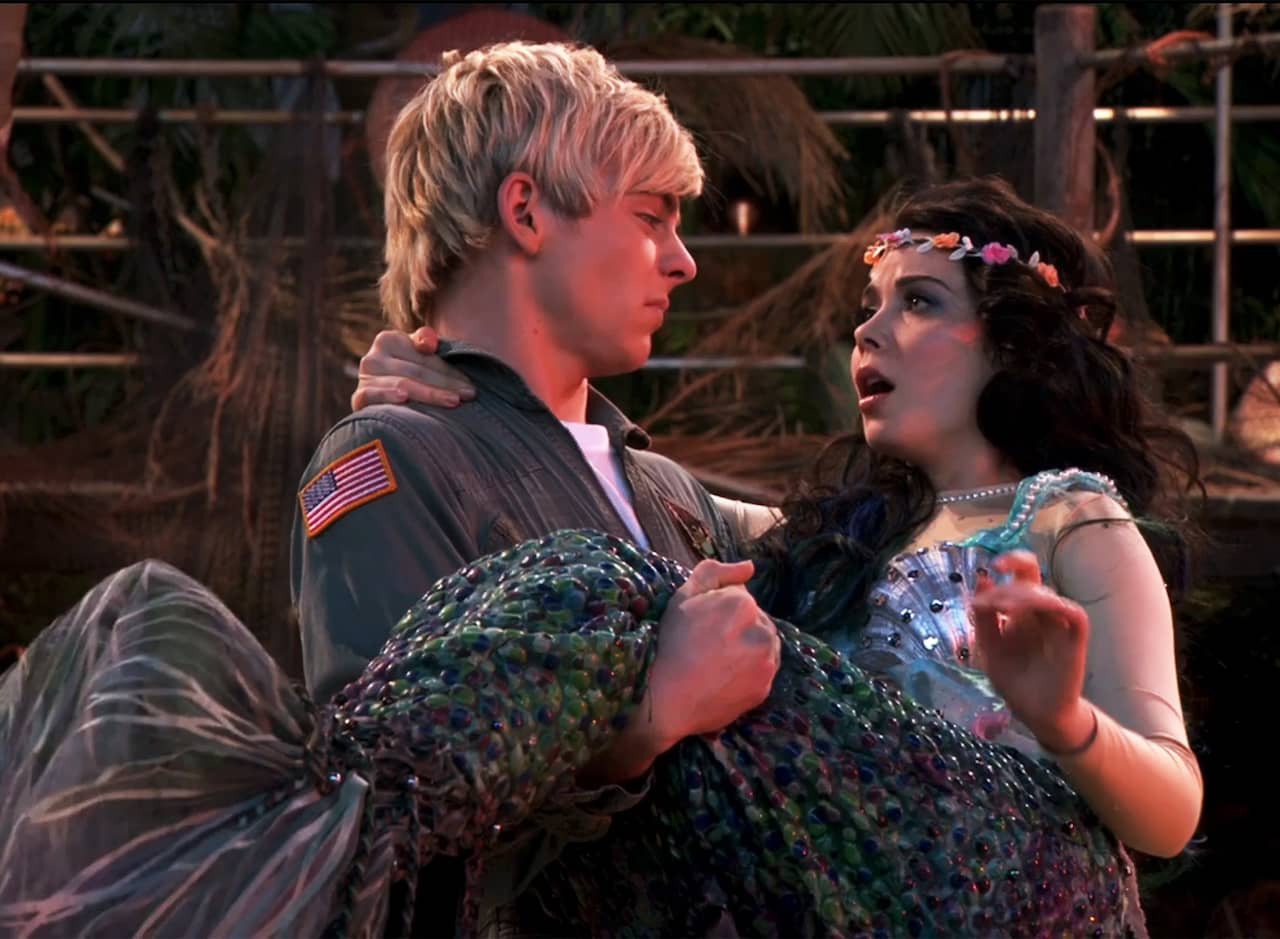 Austin Moon as a pilot, holding Brandy Baxter who is a mermaid