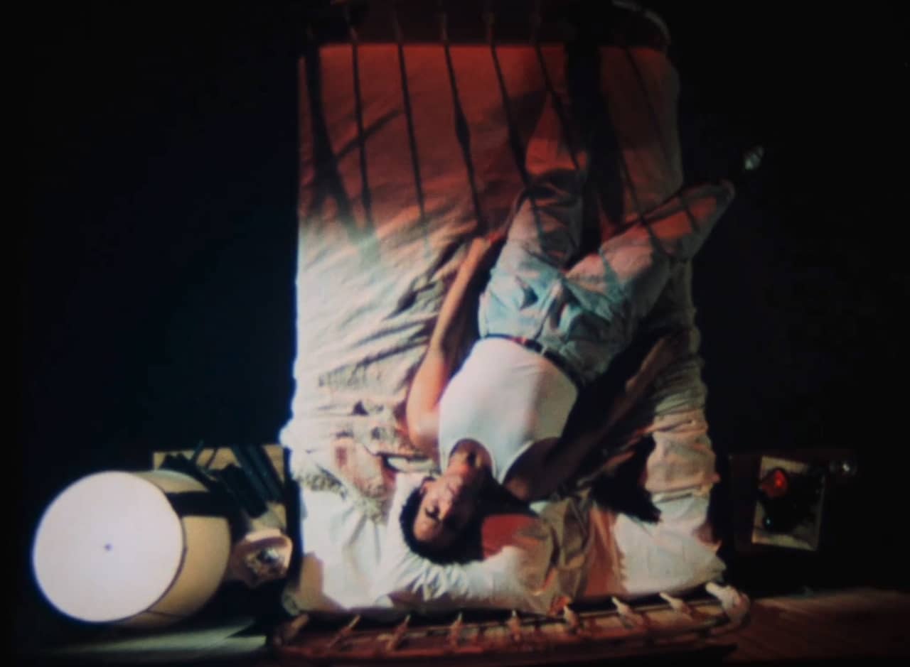 aerial shot of Roark on a motel bed