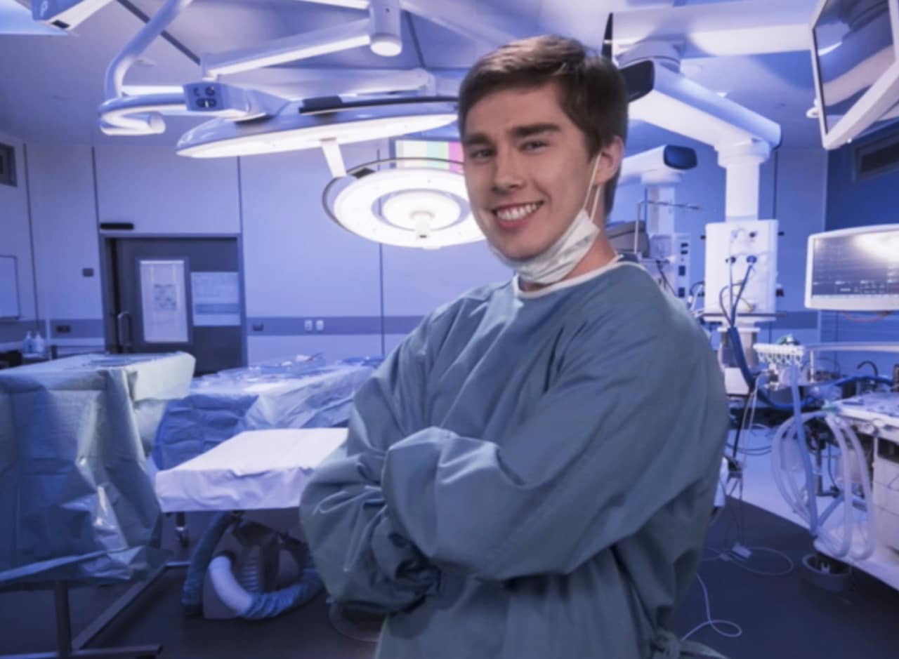 Ernie Plotz in scrubs in an operating room