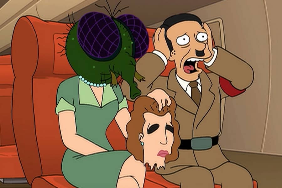 Hitler screams on a plane sitting next to his wife who has removed her face to reveal she is a giant insect