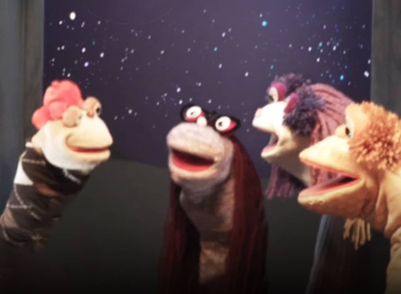 a family of sock puppets talking together