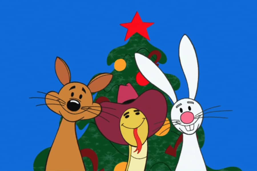 fox, snake, and bunny in front of a Christmas tree