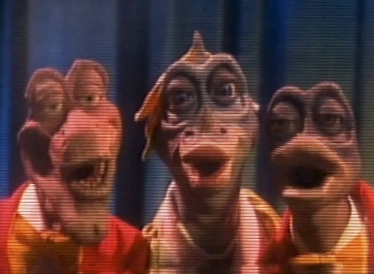 three dinosaurs in bowties singing
