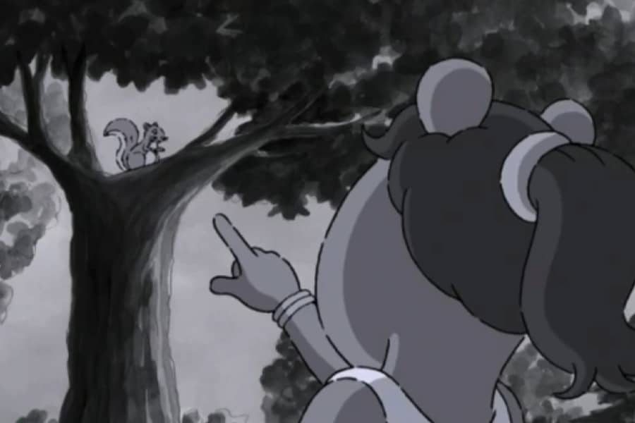 woman pointing at the squirrel in the tree