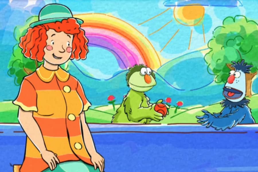 girl sits with the wuppets who are now sharing the ball
