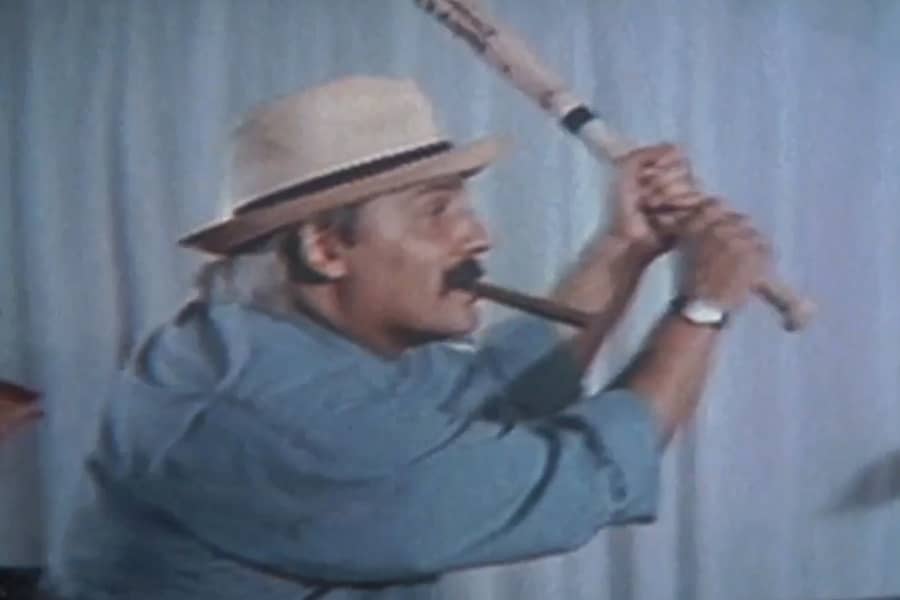 white dad smoking a cigar and swinging a baseball bat