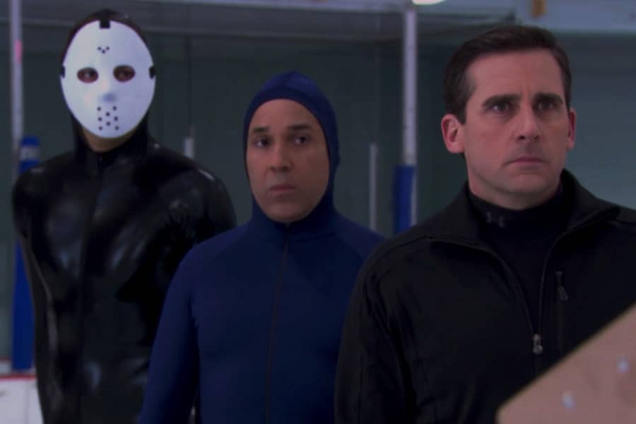 Scarn prepares for an ice race next to a man in a hockey mask