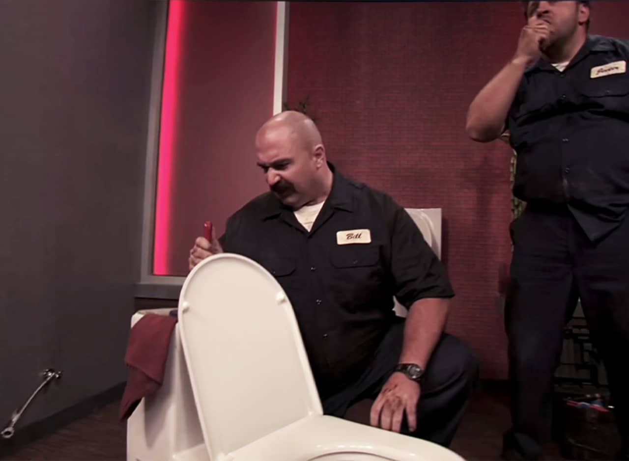 Bill and Jeeter, two plumbers fixing a toilet