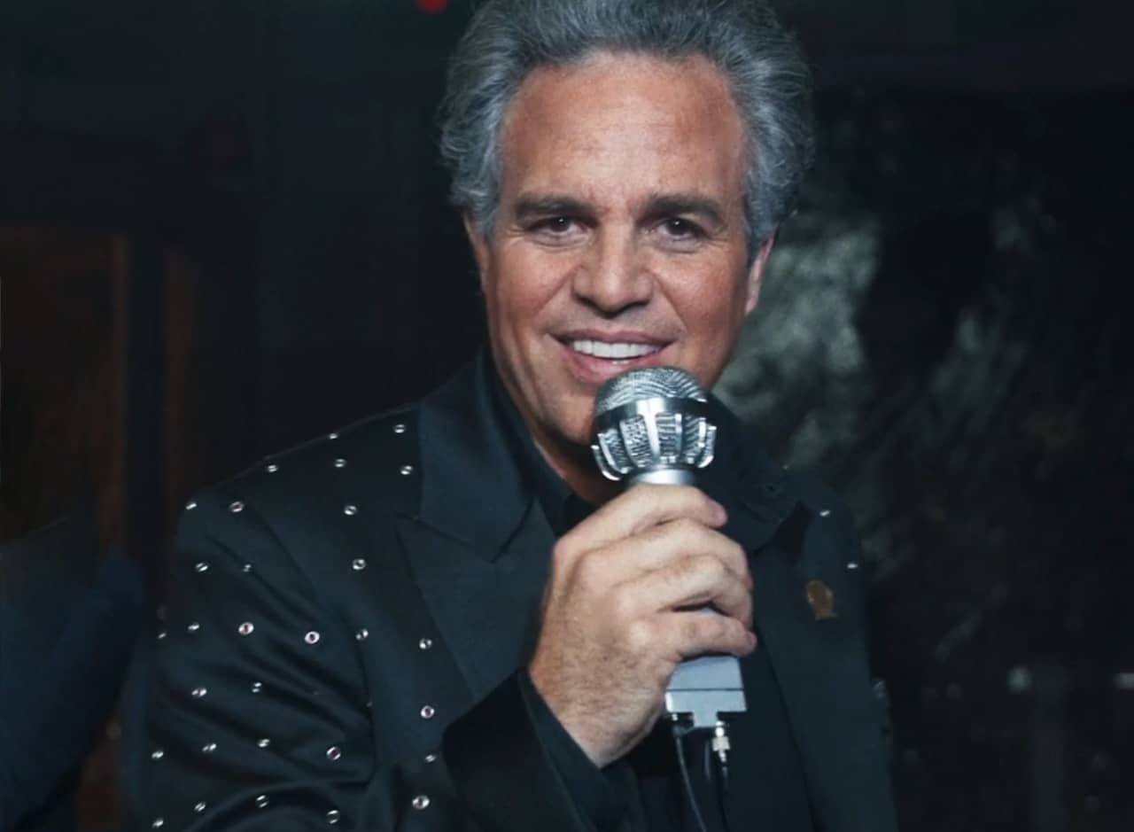 Kenneth Marshall smiling with a microphone