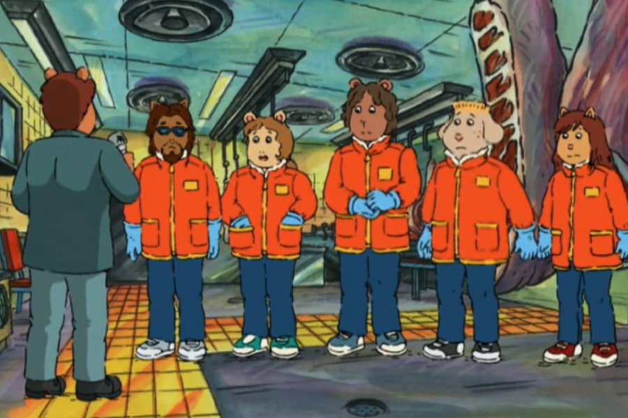 the clerks in a meat freezer wearing thick jackets and gloves