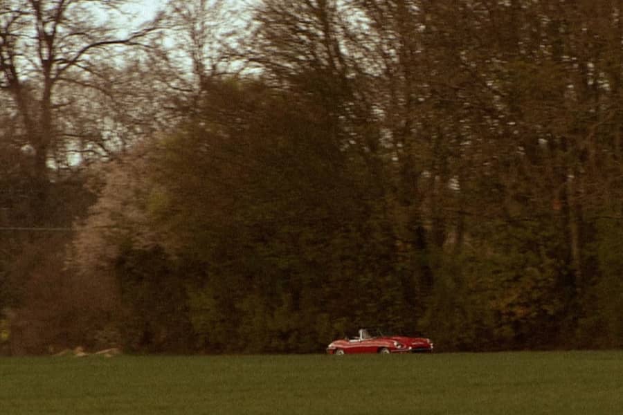 wide shot of the red convertible