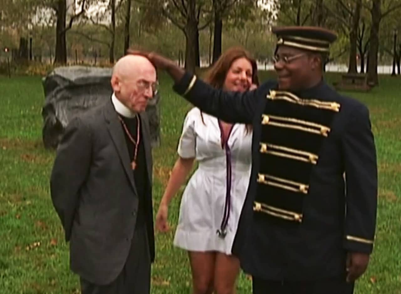 Tracy Jordan dressed as Benny Hill with a nurse and a priest in the park