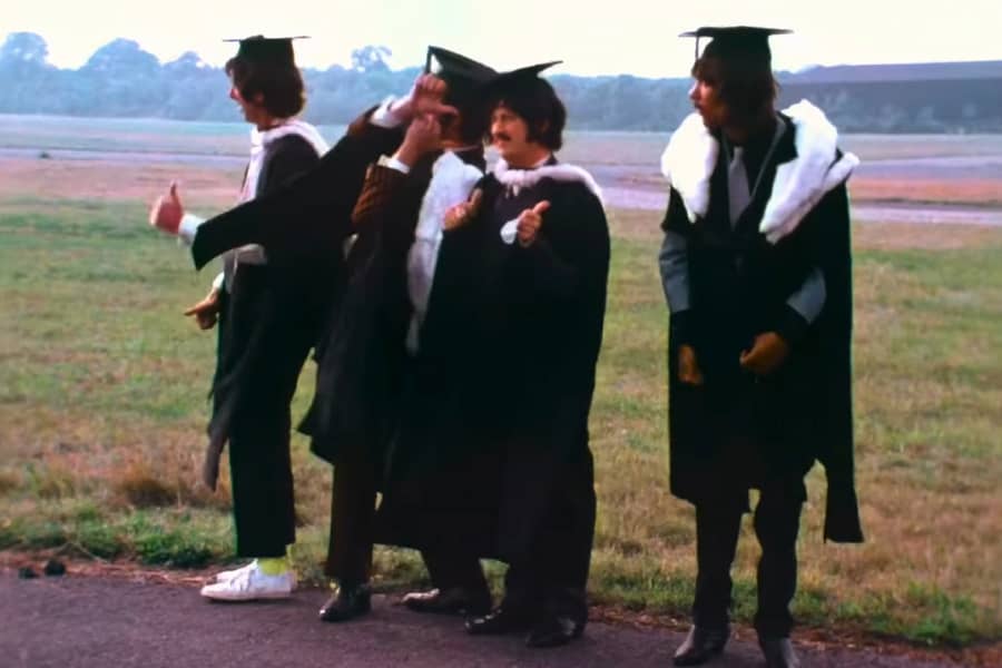 the Rutles dressed as professors on the side of the road
