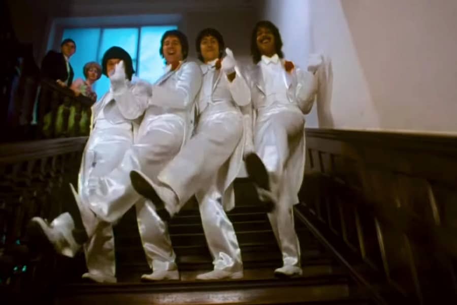 the Rutles in all white suits dancing in unison down some stairs