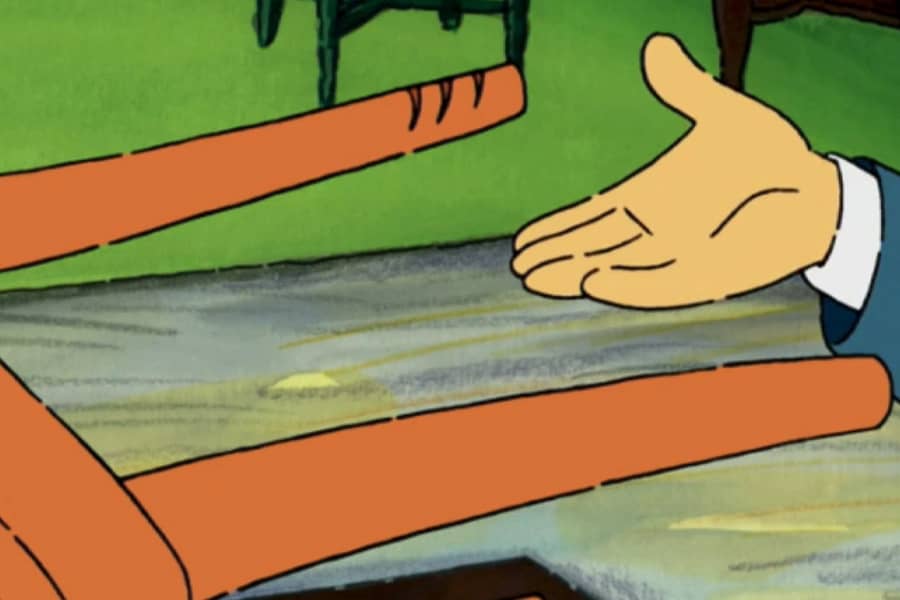 a hand showing claw marks on the leg of the chair