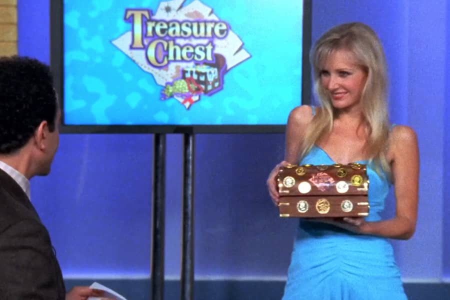 Talvo holding a mini treasure chest for a contestant