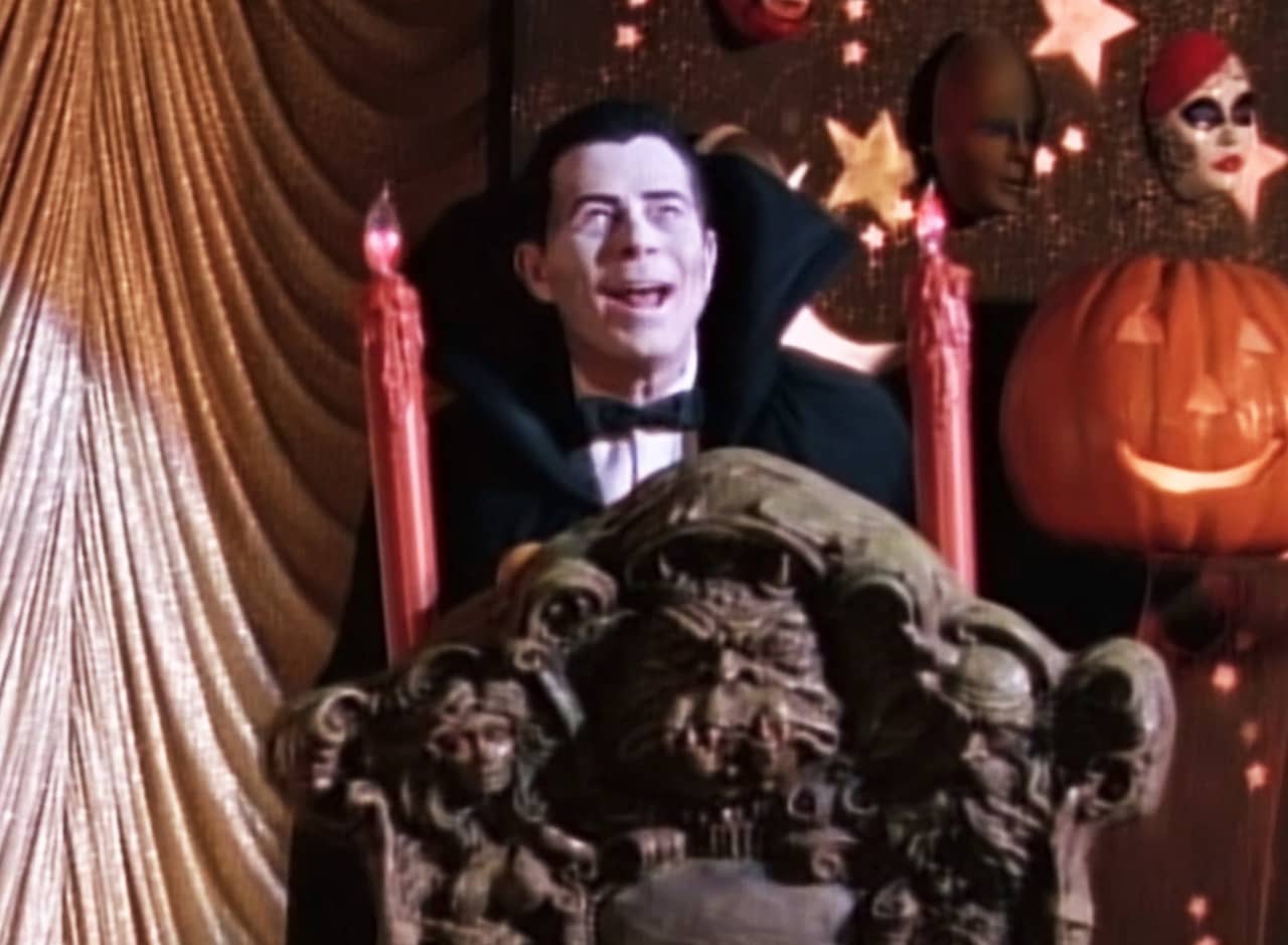 host dressed as Dracula