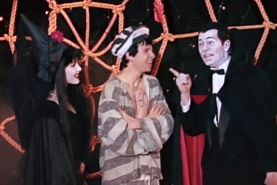 boy with Dracula host and a woman helper dressed as a witch
