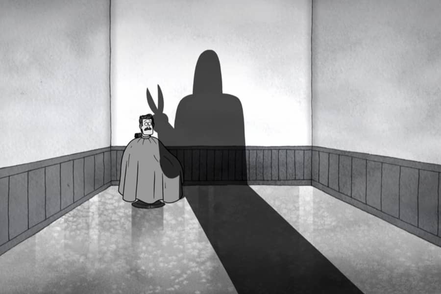 black and white shot of a guy in a barber’s chair and a looming silhouette with scissors