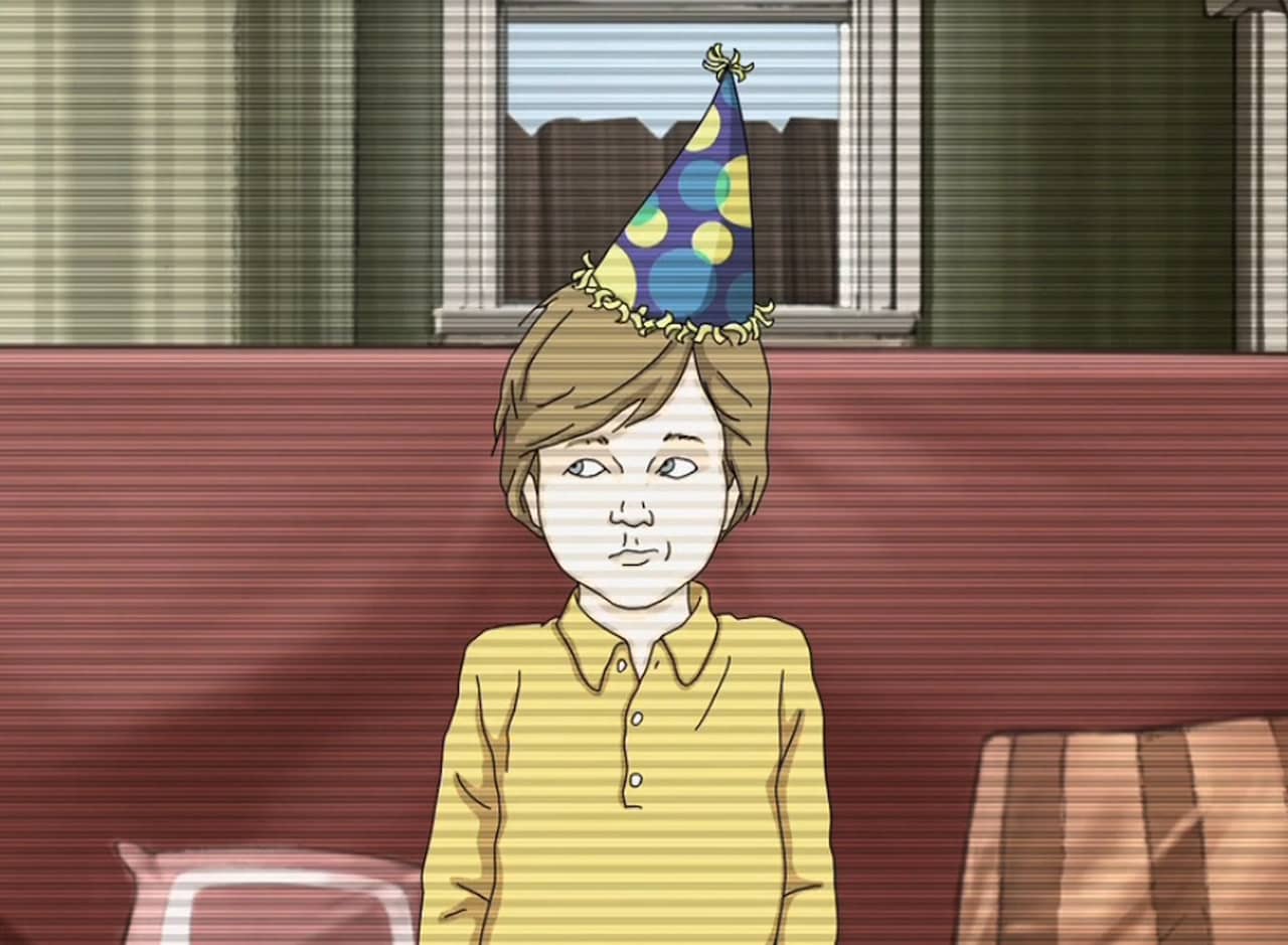 young boy sitting on the couch in a party hat