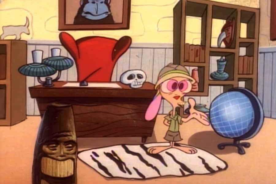 Ren in an office next to a globe