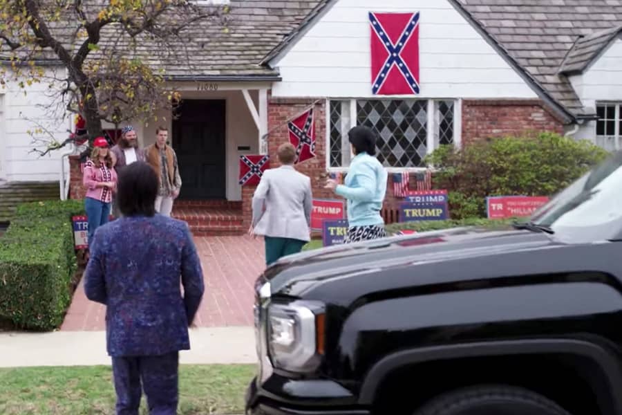 the gang pulls up to a house covered in Trump signs and Confederate flags