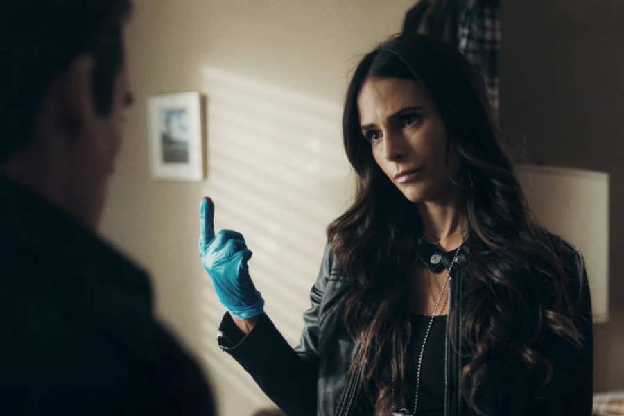 Ramsey’s partner with a blue latex glove on, blood on her fingertip